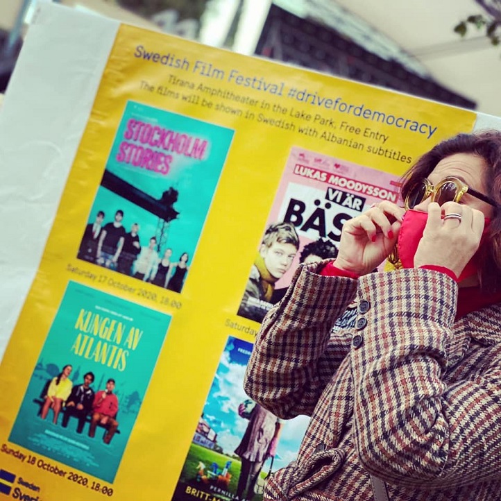 Photo of Ambassador Elsa Håstad at infront of posters at Tirana Amphitheater