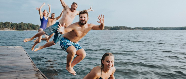 Family jumping in water