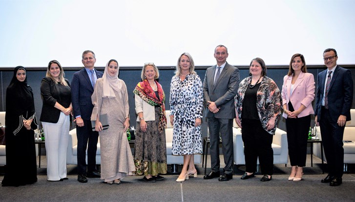 Panellists and speakers gathering for a group photo after the event