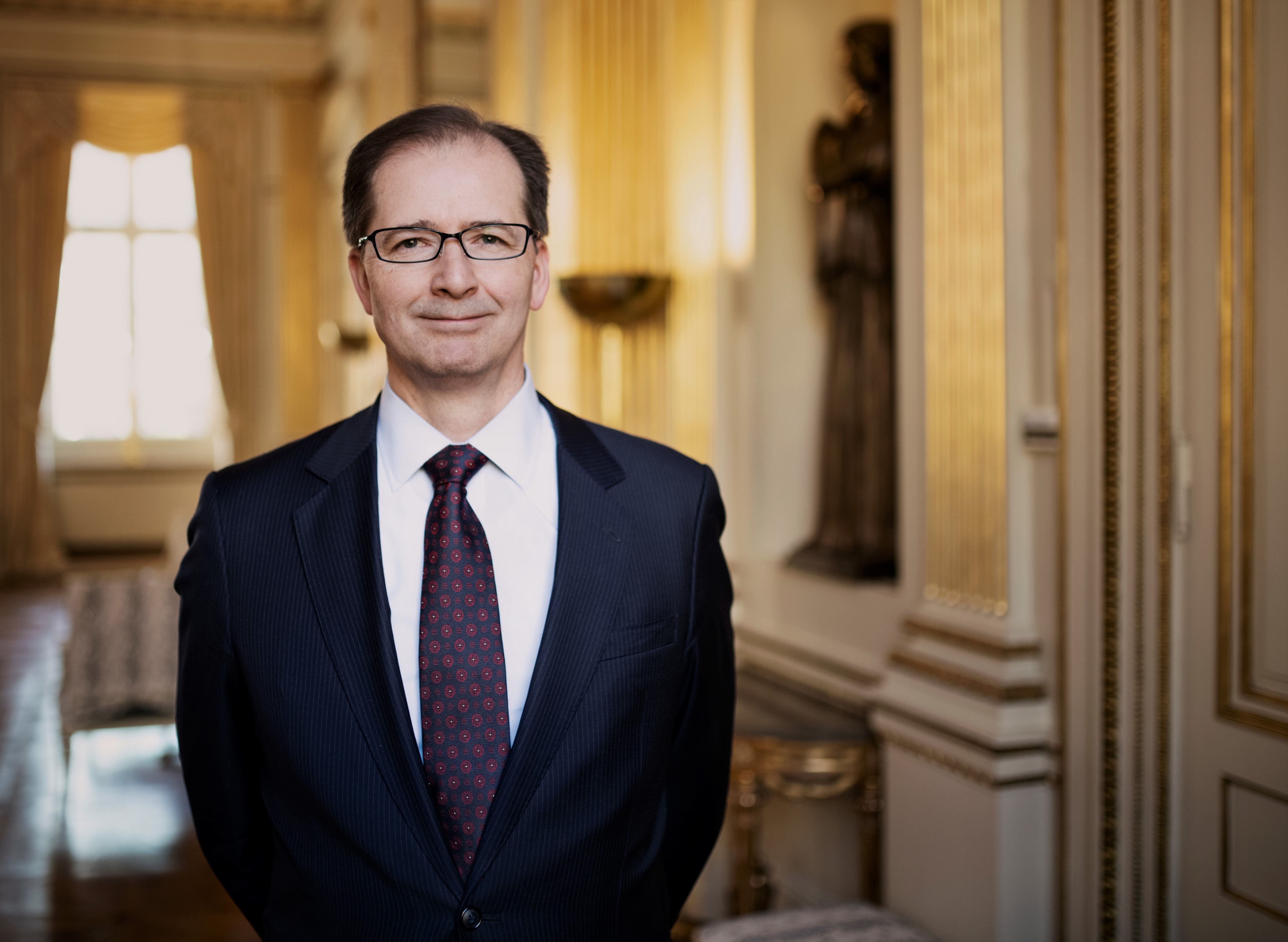 Ambassador Lennartsson is standing in a room looking directly at the camera