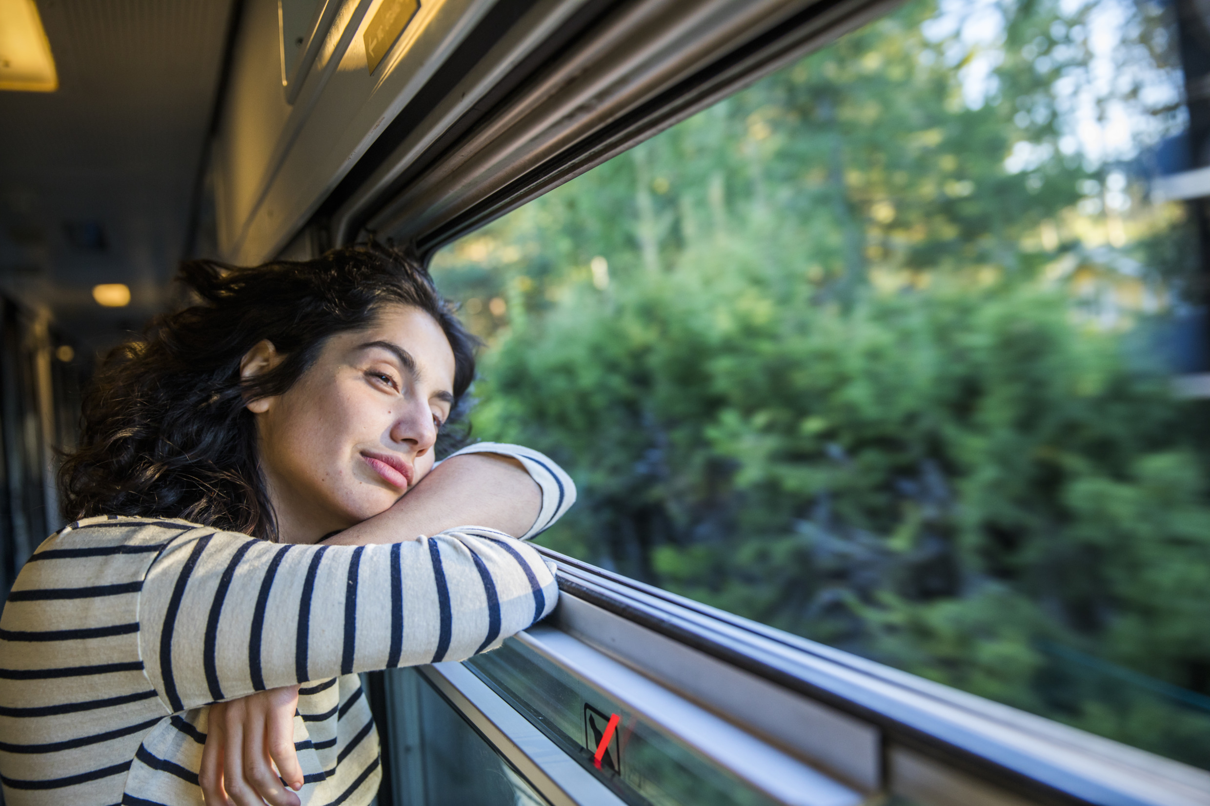 Woman looking out a train window