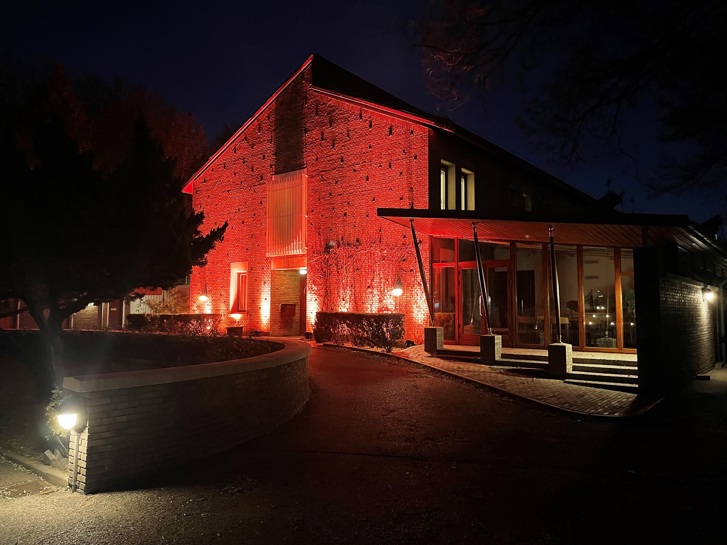 Embassy lit up in organge light