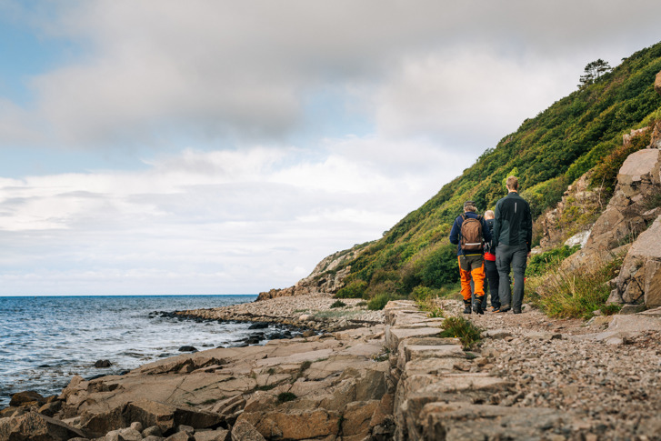 people hiking in autumn by the lake