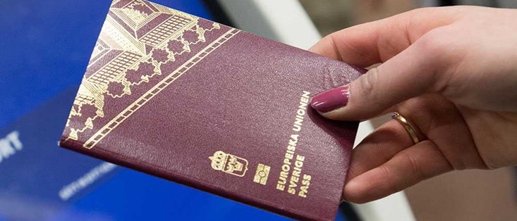 Hand holding a passport