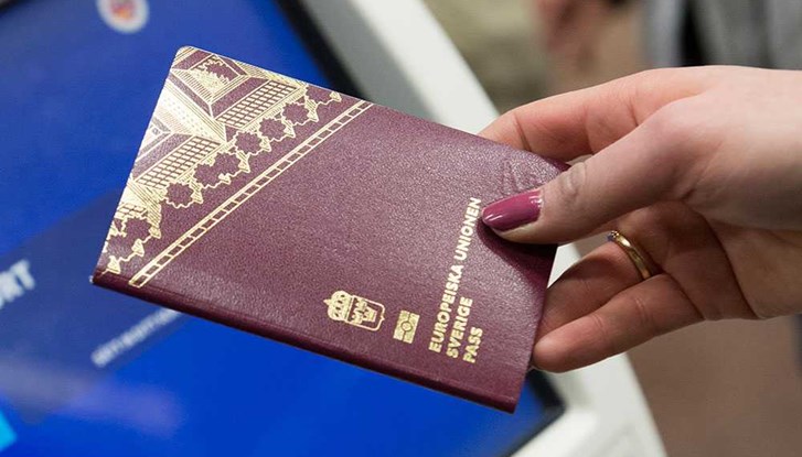 Hand holding a passport