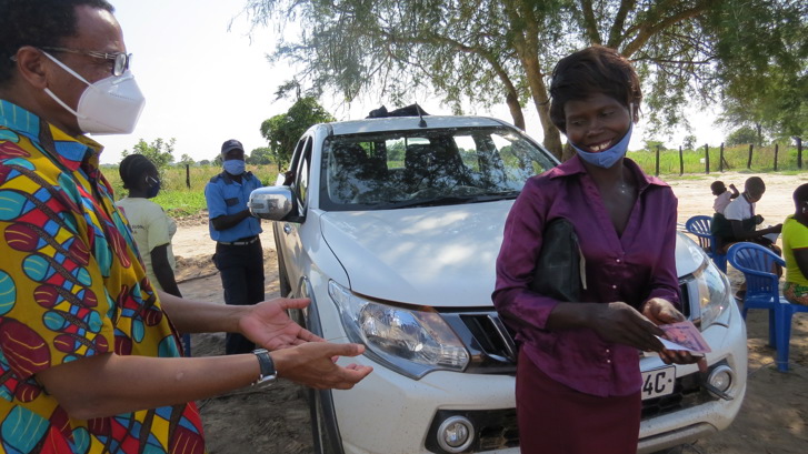 Refugee woman receiving her emergency cash transfer in Rhino Camp
